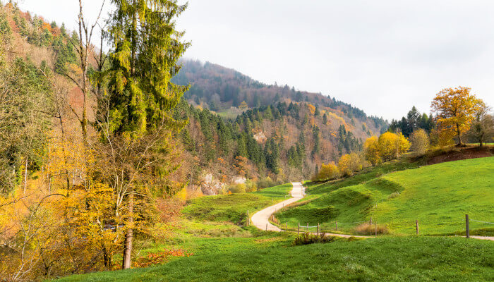 Weg durch Wiese ins Tal der Doubs mit Herbst