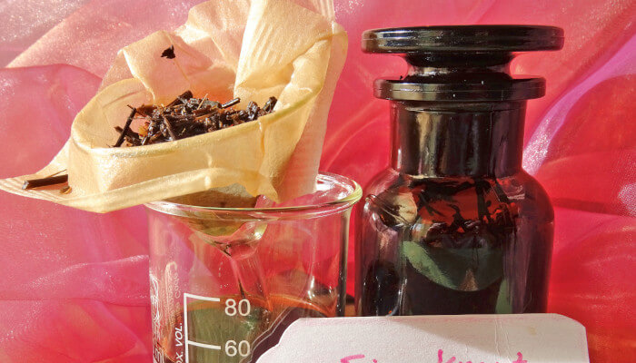 Glas mit Teebeutel und braune Flasche